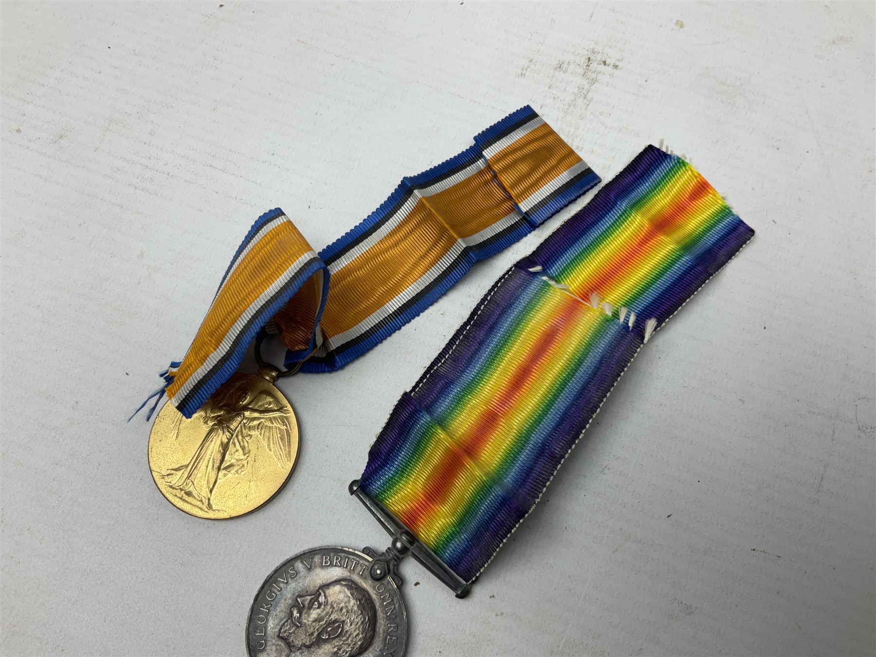 Pair of WWI medals, comprising British War medal and Victory medal, both with ribbons