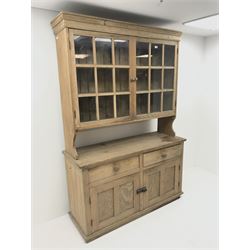 Early 20th century pine dresser, raised display cabinet, two glazed doors enclosing two shelves above two drawers and two cupboard doors 