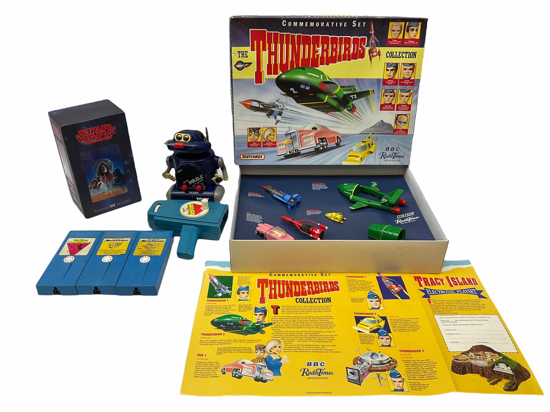 Matchbox 'The Thunderbirds' limited edition Commemorative Set, boxed with paperwork; Tomy 'Mr. D.J.' blue plastic robot radio; Mettoy Walt Disney Movie Viewer with three cassettes; and 1995 boxed set of the Star Wars trilogy VHS video tapes