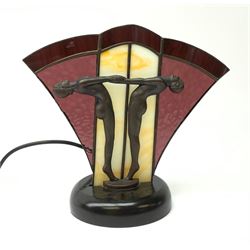 An Art Deco style table lamp, modelled in the form of two nude figures before a leaded purple and cream fan shaped glass shade, overall H26cm.