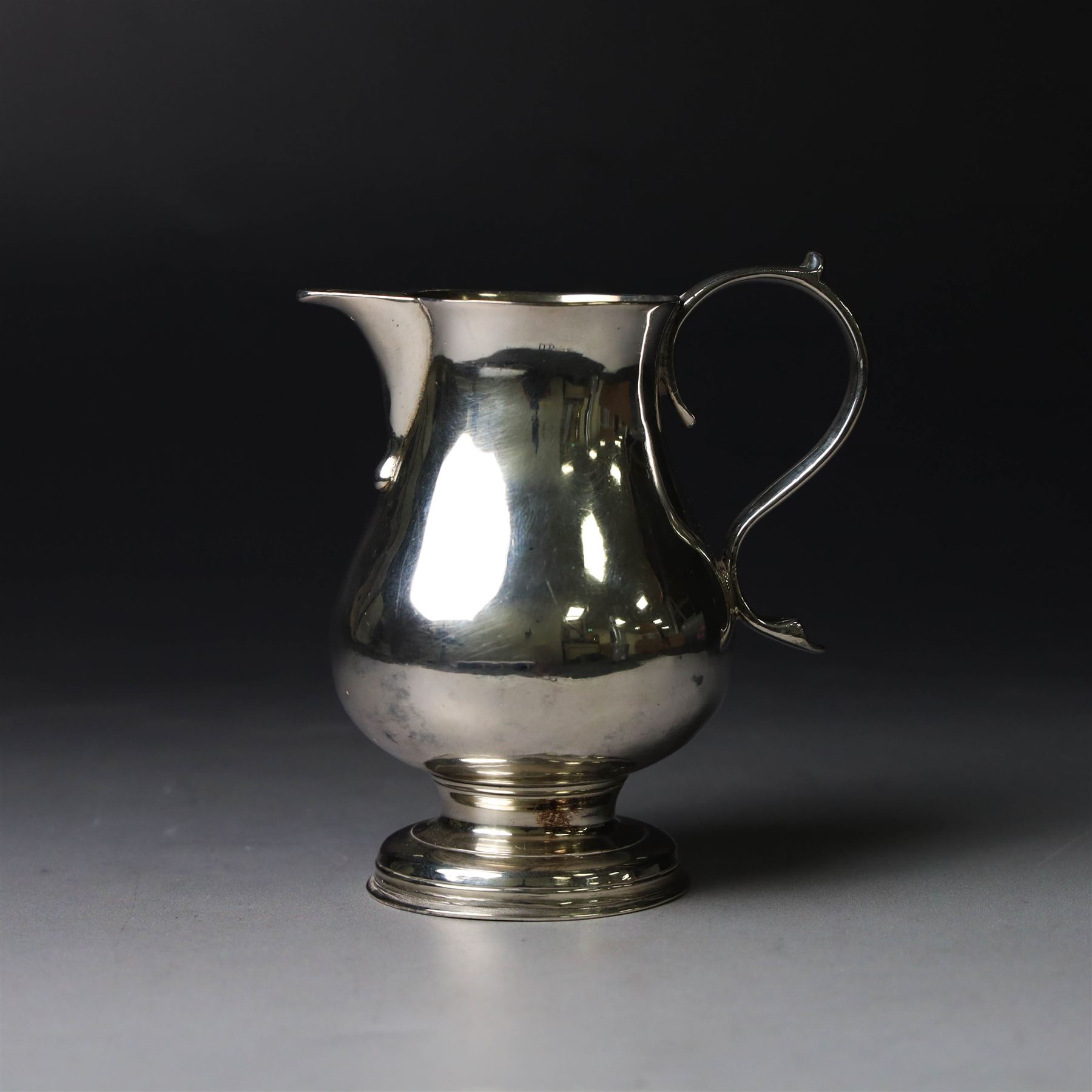 George II silver cream jug, of plain bellied form with capped scroll handle and sparrow beak, upon stepped circular foot, hallmarked London 1737, makers mark indistinct, H8.5cm

