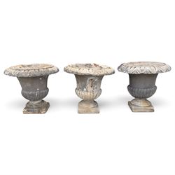 Set of three 19th century weathered carved sandstone garden urns of Neoclassical campana f...