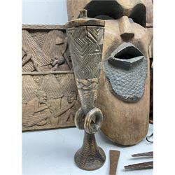Quantity of carved African art, to include spirit mask, carved wall plaques, spears, horse air fly whisk etc 