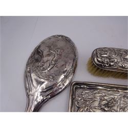 Group of silver, to include Edwardian dressing table tray, embossed with irises and a a matching clothes brush, both hallmarked Charles Henry Dumenil, London 1904 & 1905, together with a three piece silver mounted dressing table set, including hand mirror, hair brush and comb, the brush and mirror embossed with female figure amongst flowers to reverse, all hallmarked Henry Matthews, Birmingham 1910 & 1917, tray L22.5cm