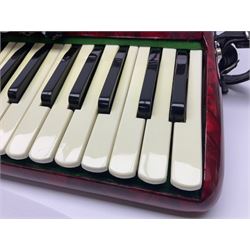 Hsinghai Studio piano accordion with red pearline finish, twenty keys and seventy-two buttons W44cm; in hard carrying case with additional The Music Room soft gig case