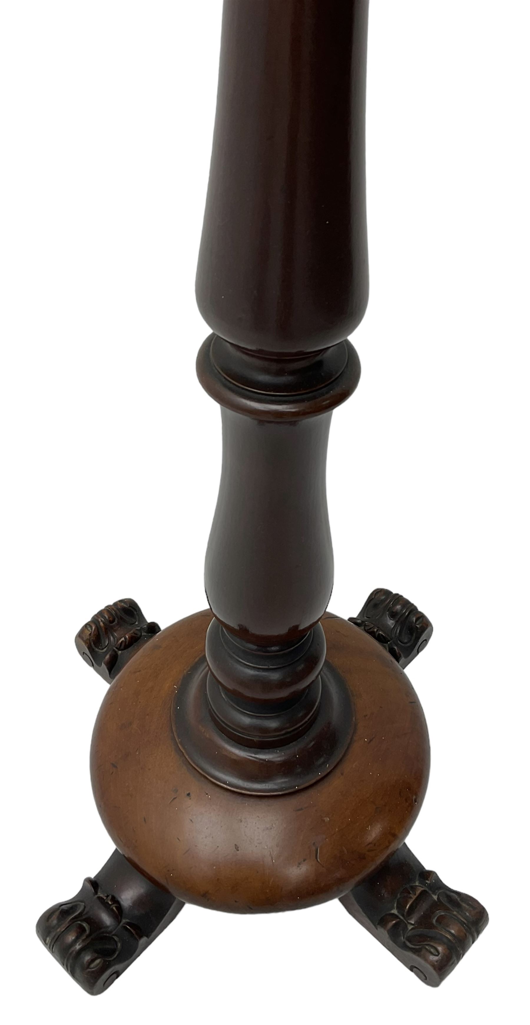 Early Victorian mahogany shaving mirror, arched frame with plain mirror plate on turned horns and supports, adjustable height mechanism on turned stem, circular platform base with four extending block feet carved with scrolled foliage 