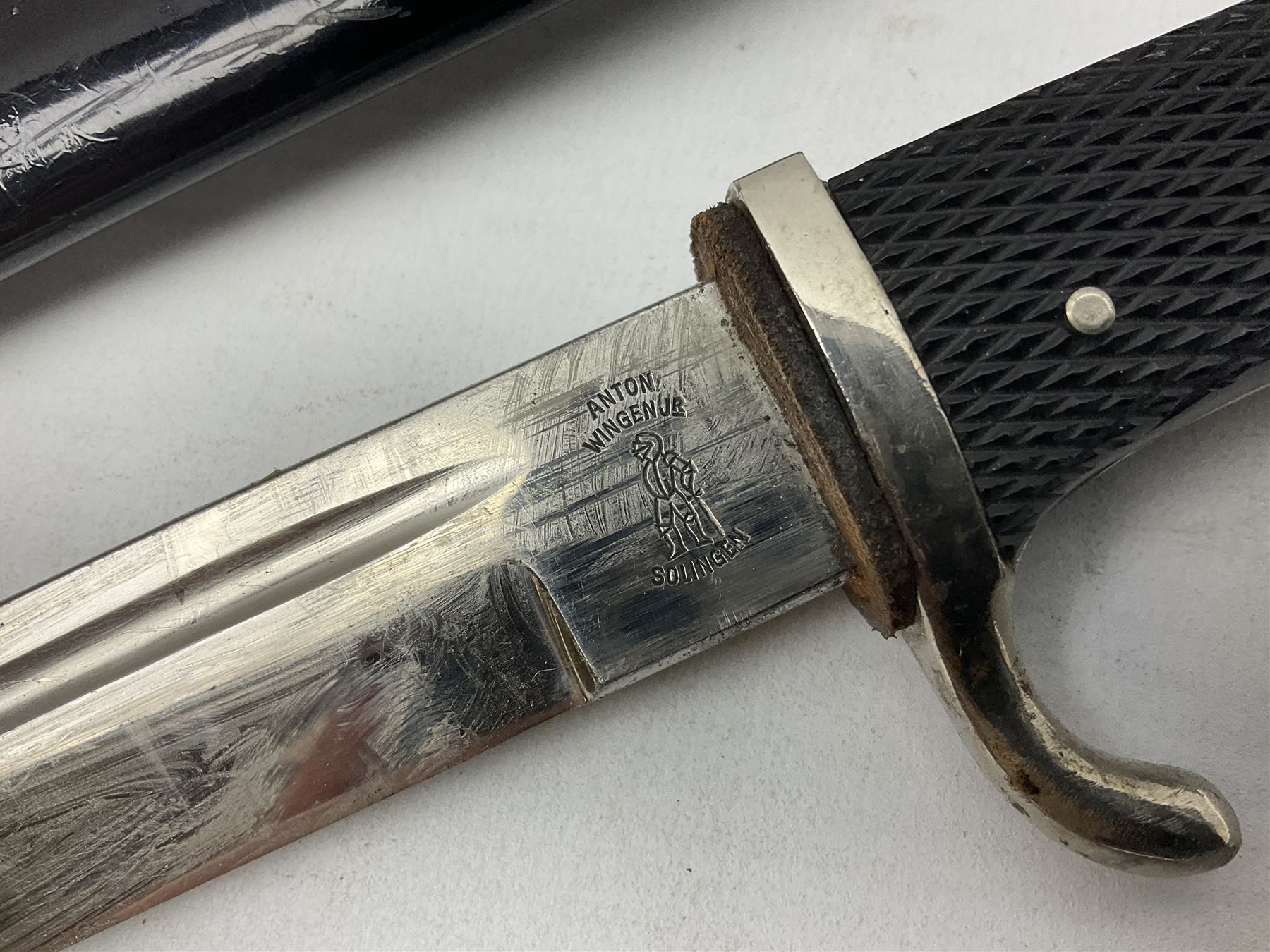 German Wehrmacht KS98 dress bayonet, with plain 19.5cm fullered blade marked Anton Wingenje Solingen, chequered black plastic grip and original leather washer to ricasso; in black painted metal scabbard L36cm overall