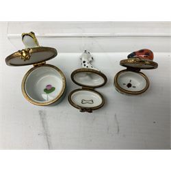 Group of Limoges trinket boxes, to include a number of novelty examples, including examples modelled as Noah's ark, shotgun case containing shotguns, picnic basket containing food, toad reading book seated upon a lily pad, etc., (9)