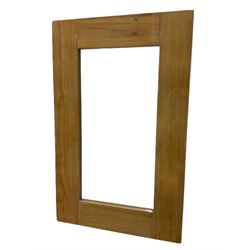 Light wood framed rectangular wall mirror