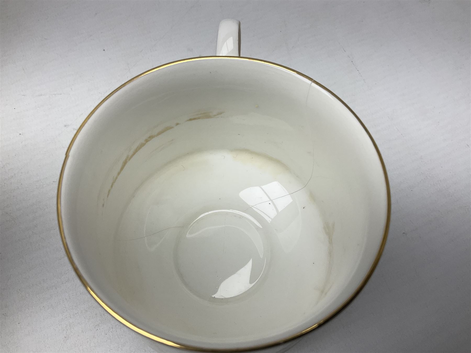 Royal Albert Paragon tea and dinner service for twelve decorated in the Belinda pattern, comprising fourteen saucers, twelve teacups, thirteen side plates, teapot, sauce boat and stand, salt and pepper shakers, two jugs, sucrier, twelve dinner plates, twelve smaller plates, two lidded tureens, twelve bowls, twelve smaller bowls, cake plate, oval plate and oval dish (100)