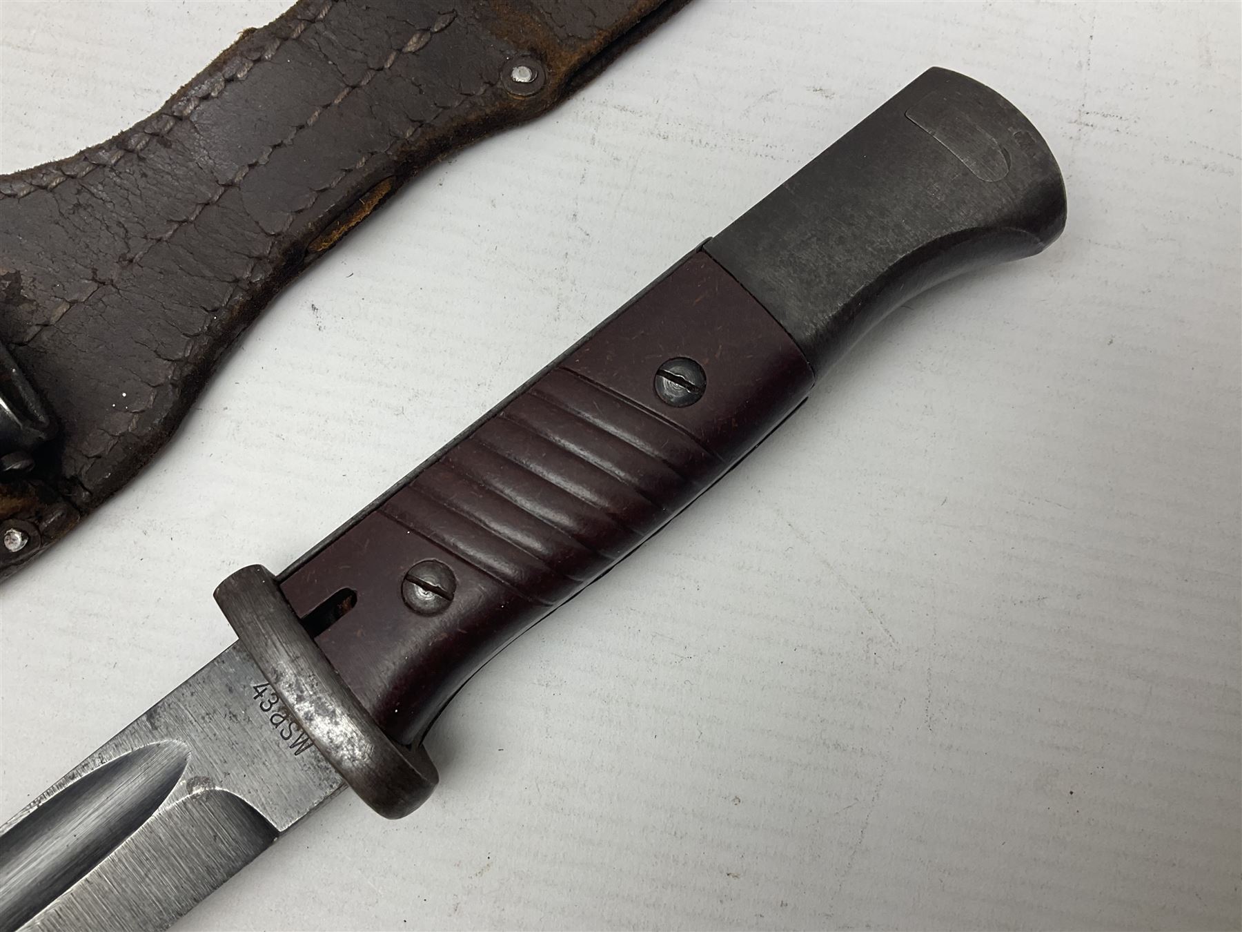 WWII German K98 Mauser bayonet by E. & F. Horster, the 24.5cm fullered blade marked 43aSW for 1943, numerous inspection marks to blade and pommel, bakelite grips and bluing to metal parts; in steel scabbard with corresponding numbers and leather frog L42cm overall
