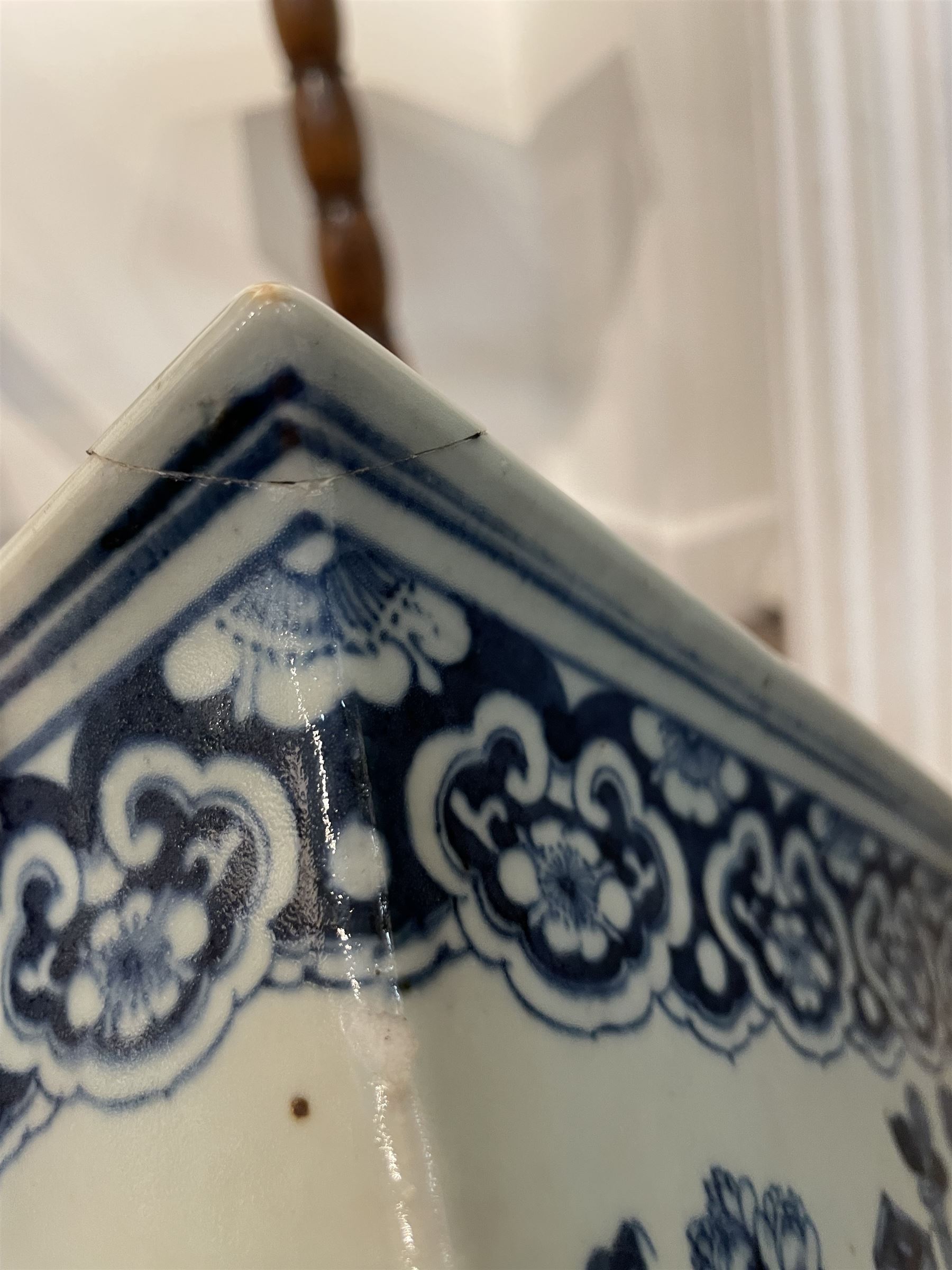 19th century Chinese blue and white planter and stand, each of square slightly tapering and flared form, the planter decorated with figures and precious objects between stylised foliate borders, the stand decorated with landscapes beneath a lipped rim with cell band, planter H28cm D25.5cm, stand H7cm D26cm