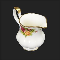 Royal Albert Country Roses tea and dinner service for six place settings, comprising teapot, milk jug, cups and saucers, dessert plates, side plates and dinner plates, all with printed mark beneath 