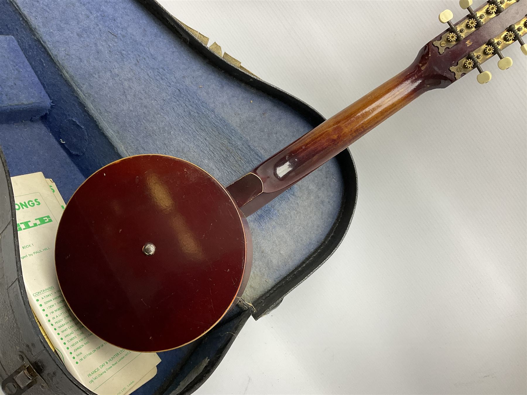 Dulcet eight-string banjo mandolin with mother-of-pearl inlaid ebonised fingerboard L55.5cm; cased; and Irish mahogany bodhran hand drum with inlaid stringing and vellum top D46.5cm; in soft carrying case with double ended beater (2)