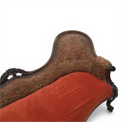 Victorian mahogany framed serpentine sofa, the shaped button upholstered back with central carved foliate cartouche, and scroll arms with carved terminals, over upholstered red seat, upon carved cabriole supports with castors