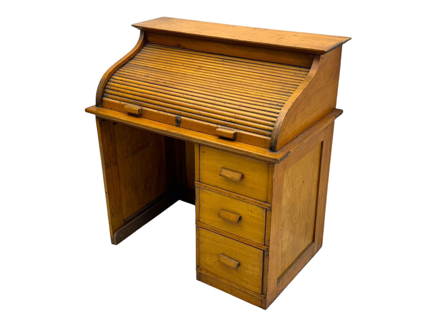 Leeway - late 19th century light oak child's roll-top desk, tambour top opening to reveal fitted interior with green felt writing surface and five pigeonholes, over three graduated drawers on the right side, raised on panelled side supports