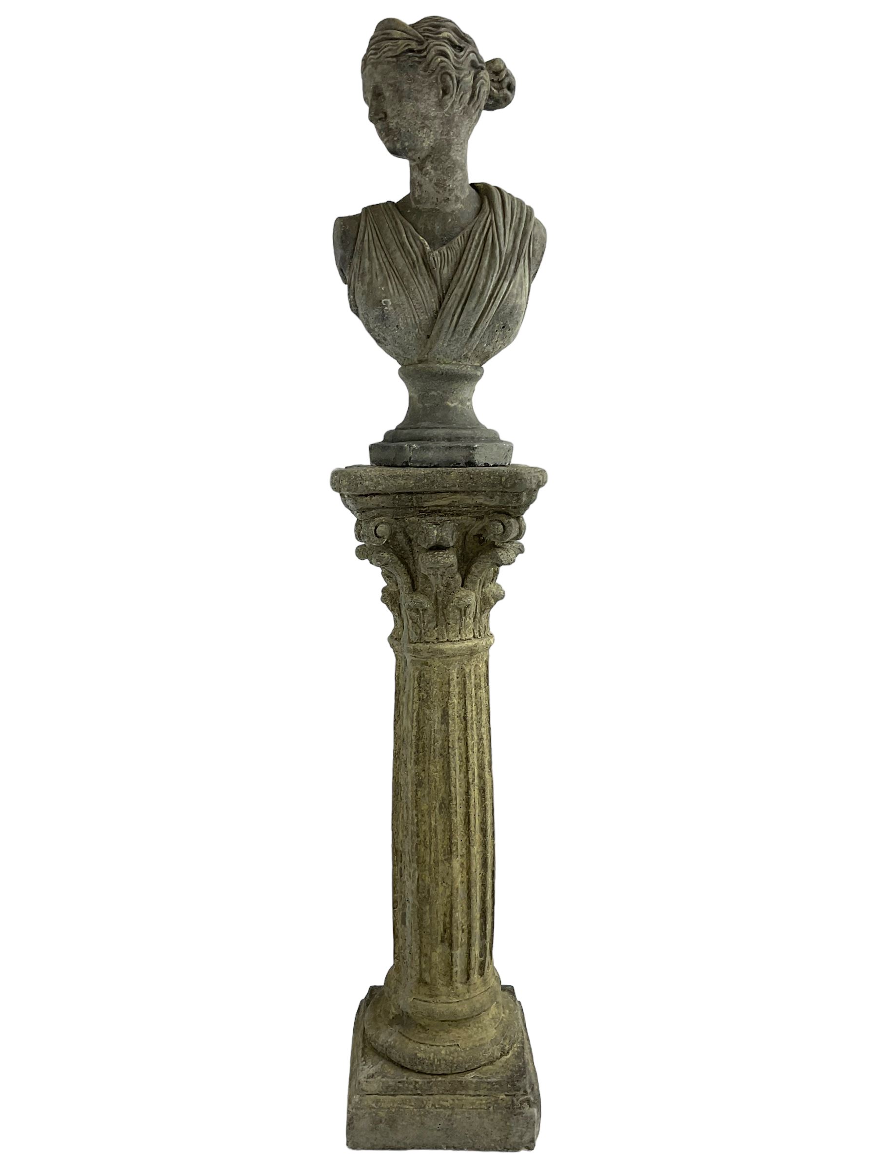 Classical design cast stone female bust depicting Artemis, raised on fluted Corinthian column with acanthus leaf capital, stepped square base, looking right 