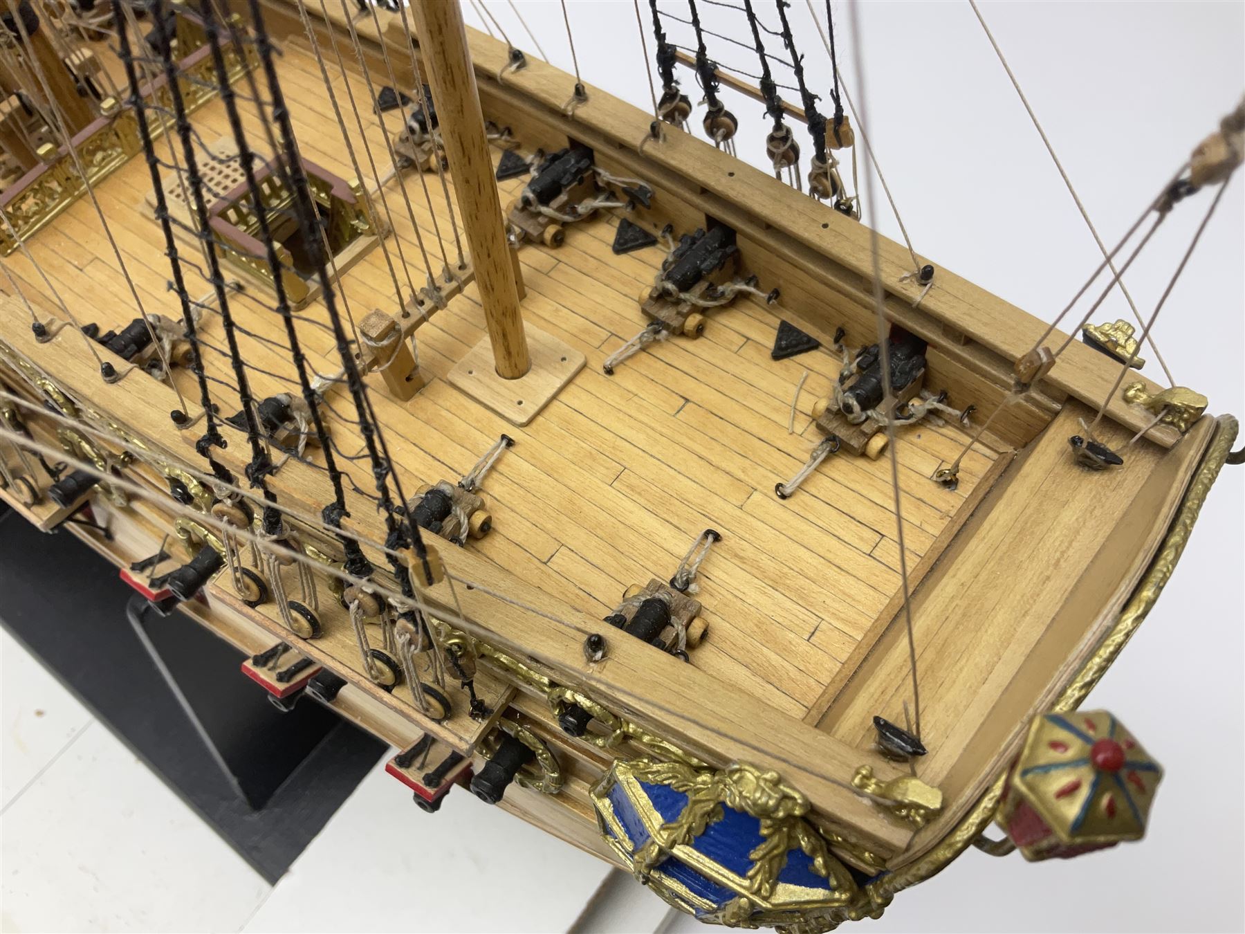 Wooden kit built model of HMS Neptune, 1:90 scale, with detailed rigging to three masts and a row of cannons to either side, upon ebonised wooden base, including stand H71cm