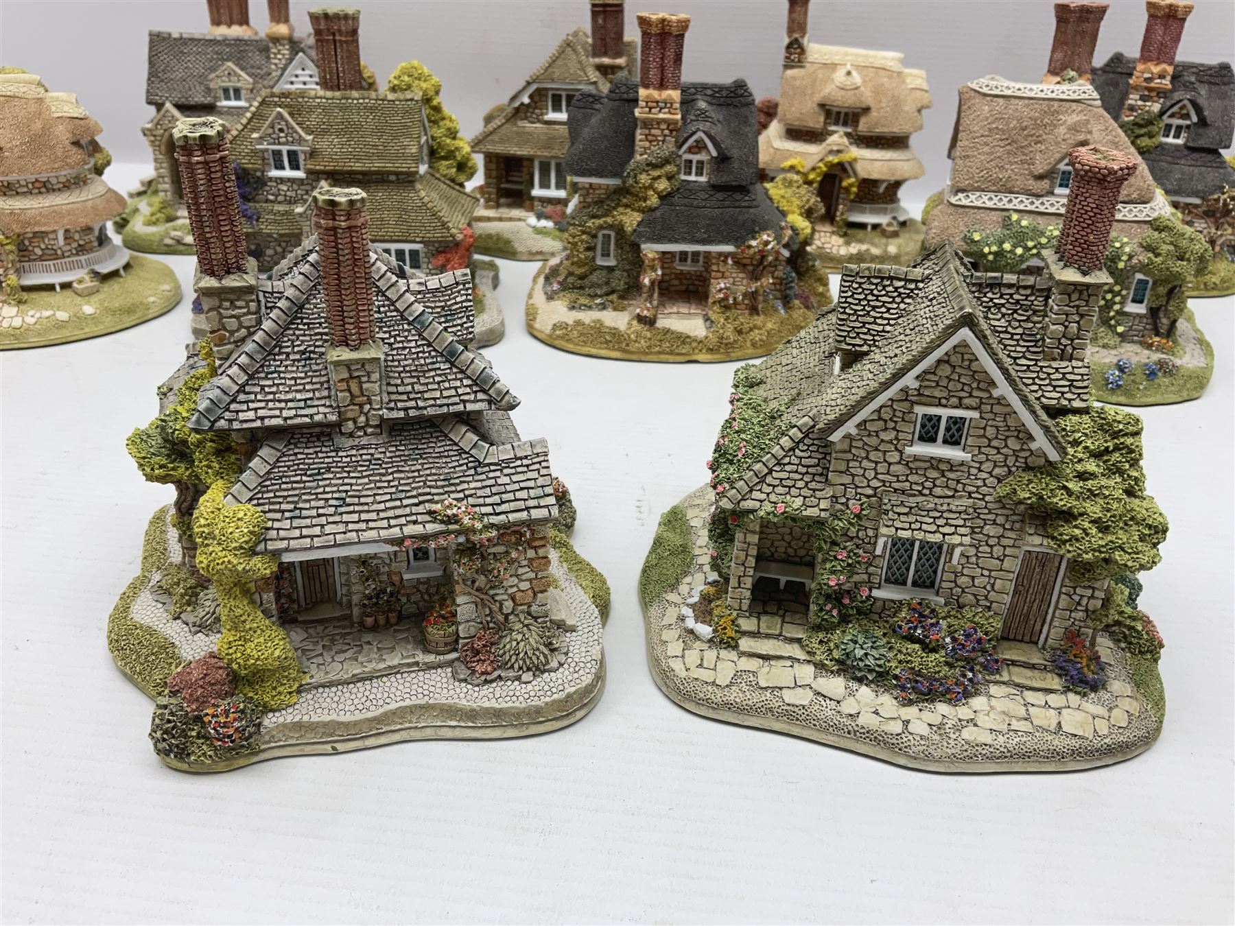 Eight Lilliput Lane limited edition Beatrix Potter models, including Buckle Yeat, Tabitha Twitchits Shop and Ginger Pickles Shop, together with twelve Lilliput Lane models from the Blaise Hamlet collection, including Dial Cottage, Diamond Cottage and Vine Cottage, all with deeds and original boxes (20)