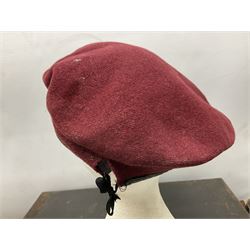 Assorted militaria including ten leather or canvas cartridge and other belts, maroon beret with 17th Lancers cap badge, modern bullet mould, leather and brass shot flask, two knives, shell cases, boomerang etc; in tin deed box