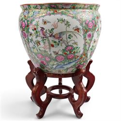 20th century Chinese famille rose fishbowl, decorated with birds in foliage, on hardwood stand, H43cm