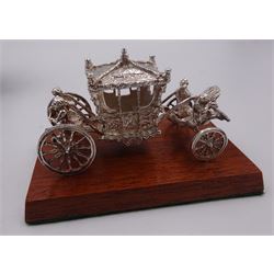 Modern silver miniature model of the coronation carriage, upon a wooden plinth, hallmarked Toye, Kenning & Spencer, Birmingham 1977, approximate weight 2.37ozt (73.72 grams) contained within makers box