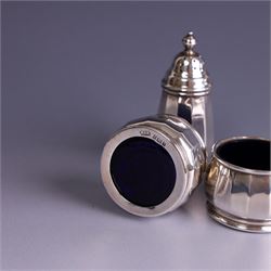 Mid 20th century three piece silver cruet set, comprising pepper shaker, open salt and mustard pot with cover, each of circular faceted form, hallmarked Walker & Hall, Birmingham 1958, the mustard pot and salt with blue glass liners