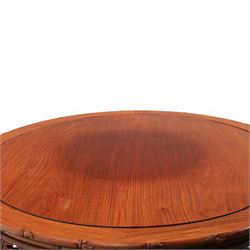 20th century Chinese ornately hardwood dining table and chairs, circular table with 'Lazy Susan' top with pierced carved frieze, raised on a quadriform base with carved foliate detail, the chairs en suite with carved pierced detailing  