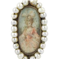 19th century portrait ring, set with an oval miniature of a woman wearing a pink dress on ivory, under a glazed panel, with threaded pearl surround and engraved shoulders. This lot has been registered for sale under Section 10 of the APHA Ivory Act