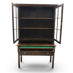 Early 20th century Jacobean Revival dark stained oak dresser, the associated upper section enclosed by twin glazed doors with shaped moulded glazing bars, over separate base fitted with two drawers, raised on bobbin turned legs