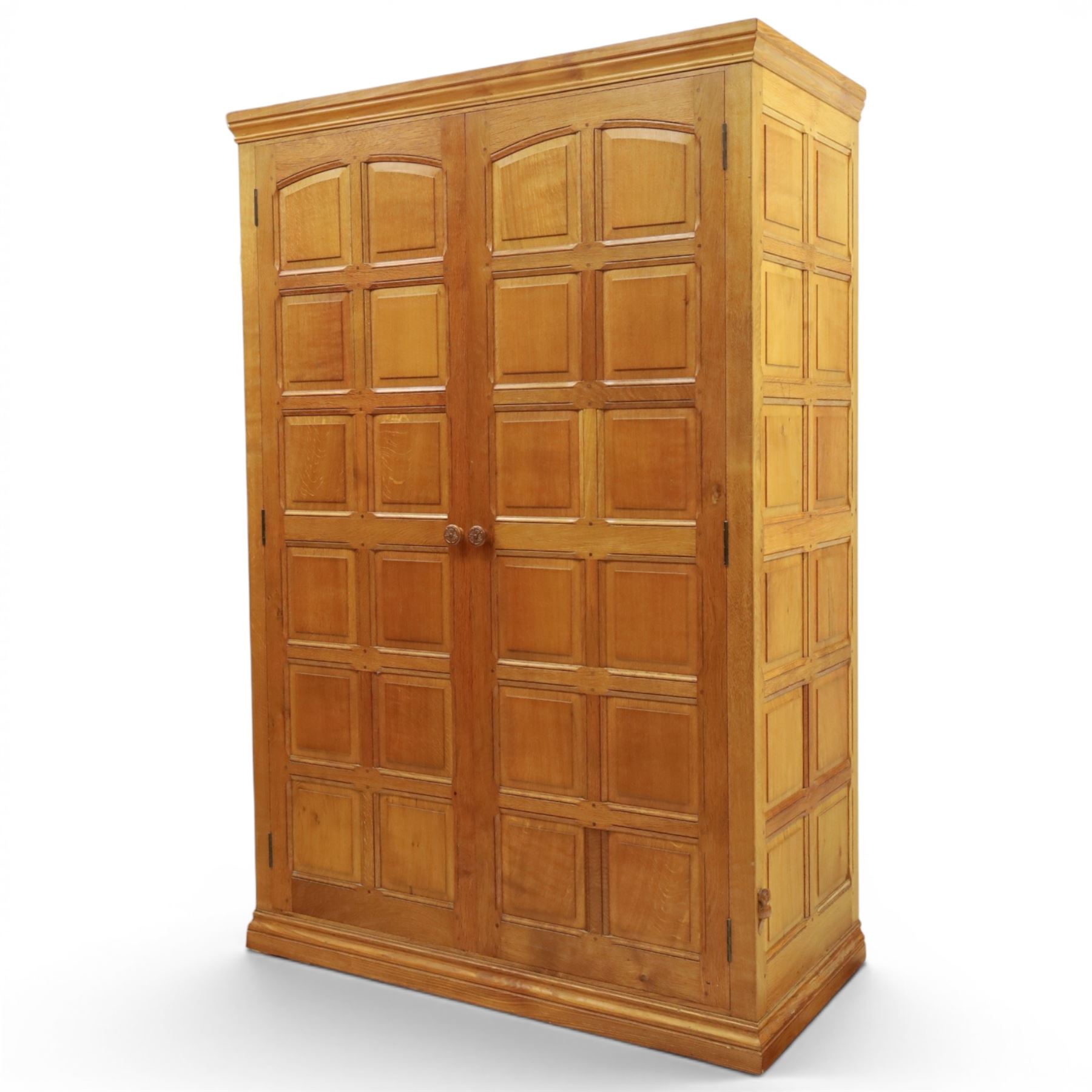 Beaverman - oak double wardrobe, enclosed by twin multi-panelled doors, Yorkshire Rose carved handles, the interior fitted with shelf and hanging rail, with signature carved beaver, by Colin Almack of Sutton, near Thirsk