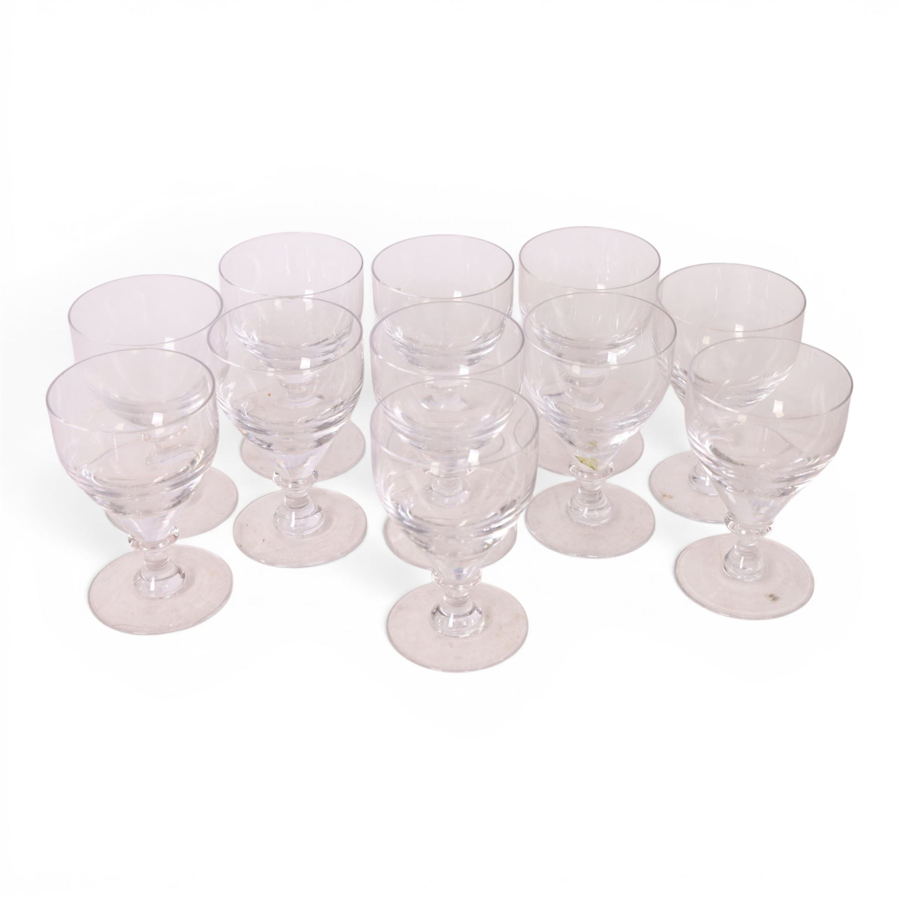 Georgian shaped drinking glasses, comprising eleven larger, H12.5cm, and eight smaller, H10.5cm, each with ovoid bowl upon knopped stem and circular foot