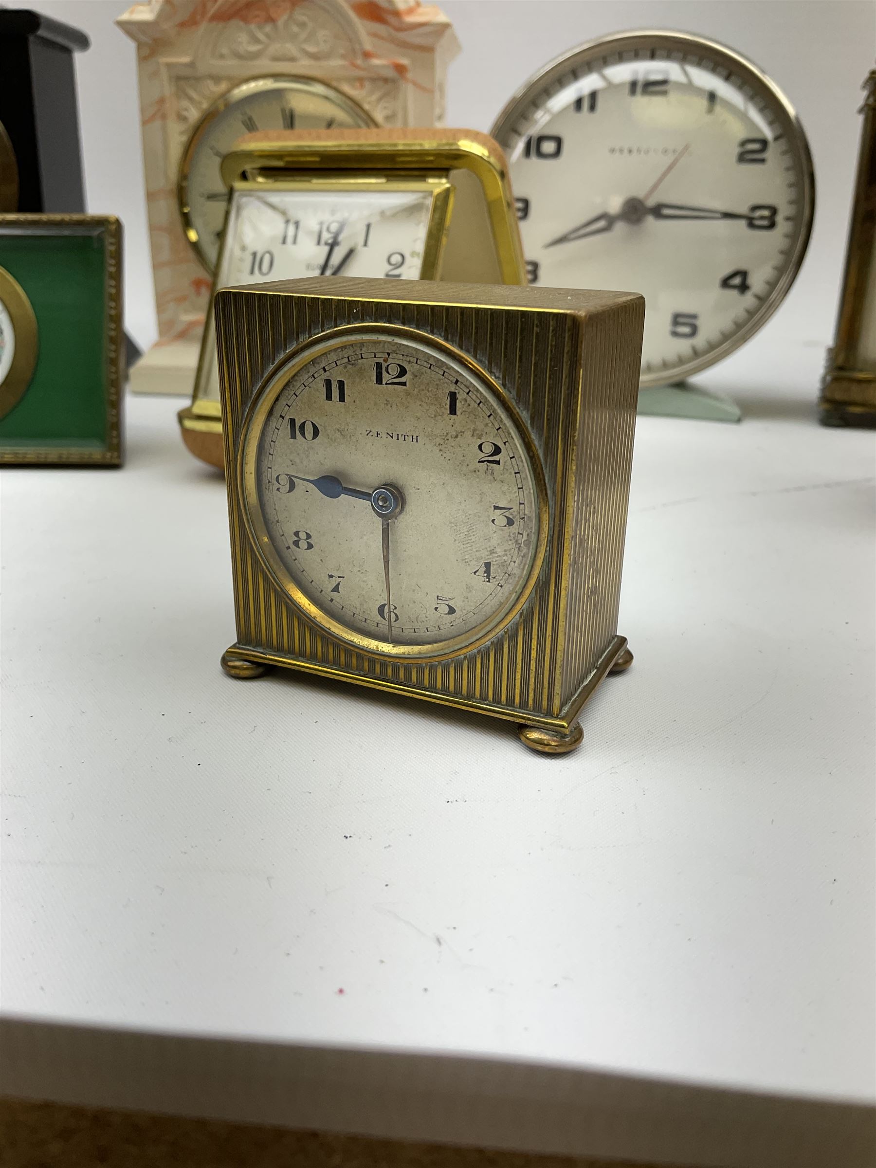 Miniature 'Zenith' travel alarm clock, in engine turned brass case with