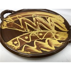 Studio pottery circular tray in brown glaze with cream decoration, with twisted rope detail twin handles, impressed mark beneath, W46cm