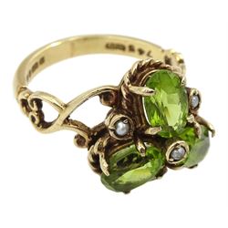 9ct gold three stone oval peridot and seed pearl ring, with open scroll design shoulders, London 1976