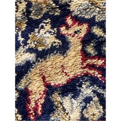 Persian Kerman ivory ground rug, the field adorned with naturalistic depictions of birds, animals and floral designs, framed by a multi-band border in blue and red tones