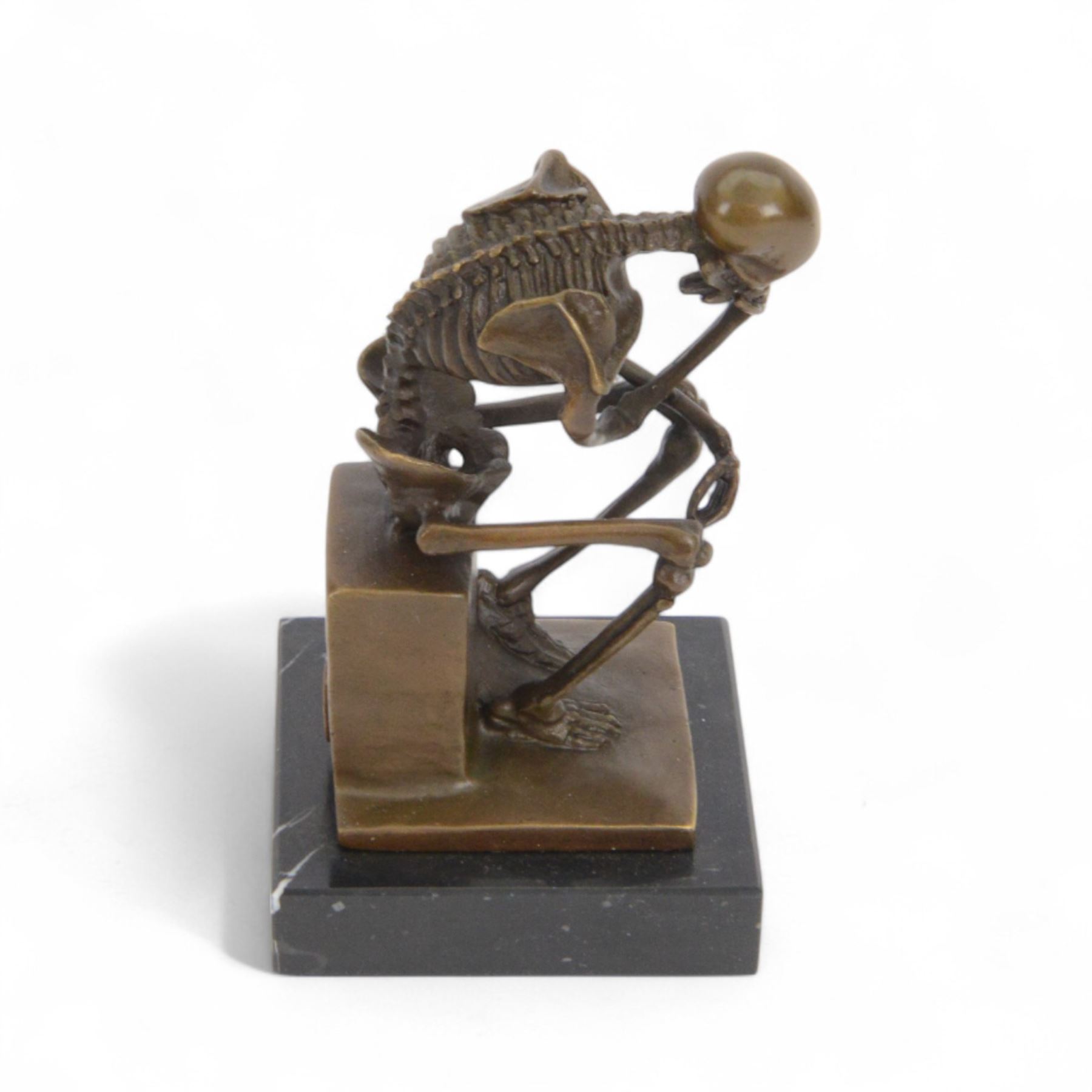 Bronze figure of skeleton modelled as The Thinker, on black marble base, signed and with foundry mark, H14cm