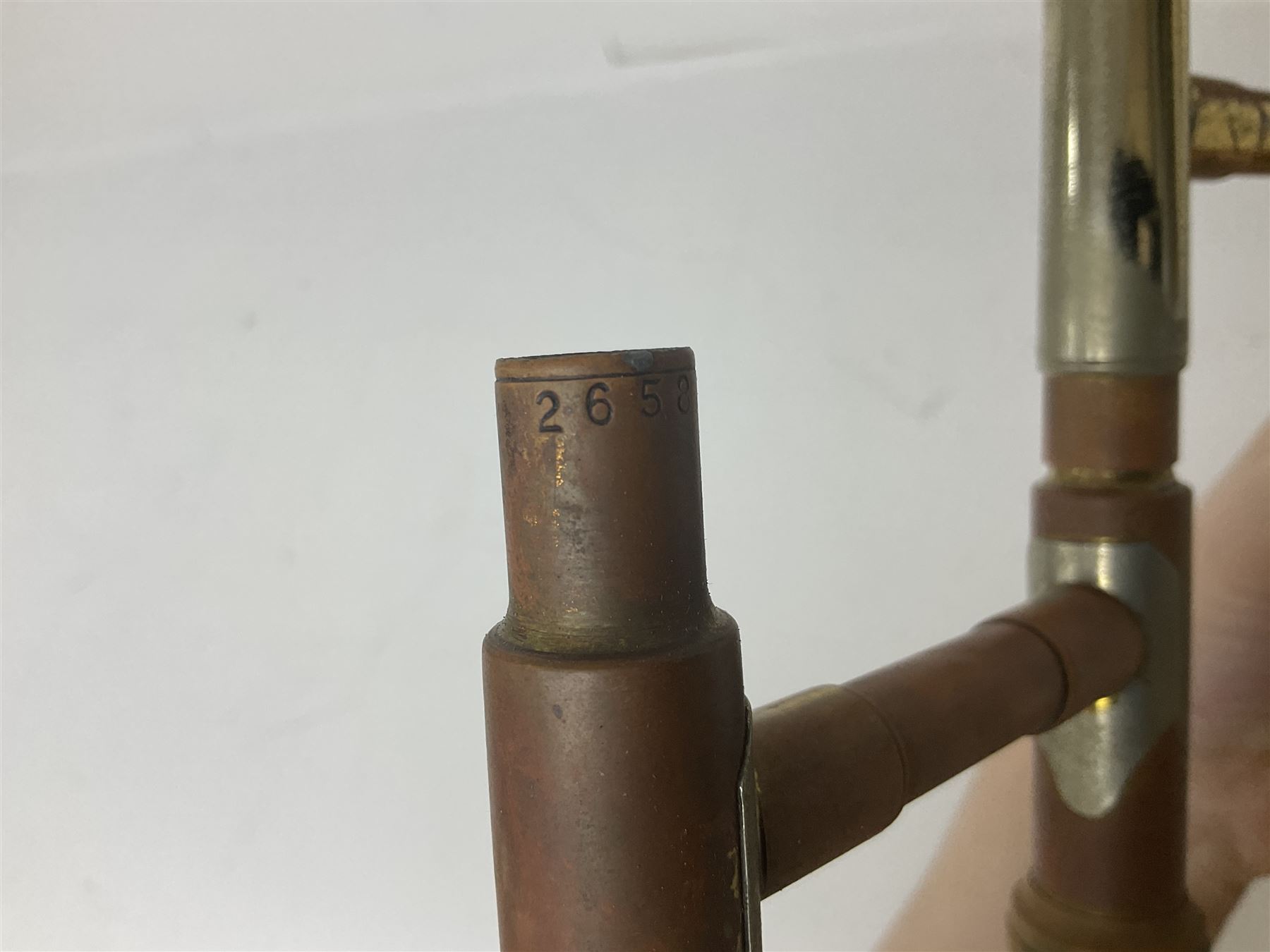 Three brass trombones comprising Elkhart Ind. USA 'CONN' model no.72H; Besson 'Concord'; and Selmer Distributed 'Lincoln'; two in carrying cases; and German B & M 'Champion' brass trumpet (4)