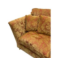 Duresta - two seat sofa, upholstered in red and gold patterned fabric decorated with scrolling foliage, on turned front feet with brass cups and castors