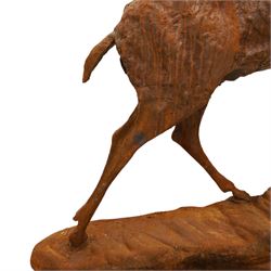 Pair of cast iron stags, upon a on moulded rocky plinth, standing alert 