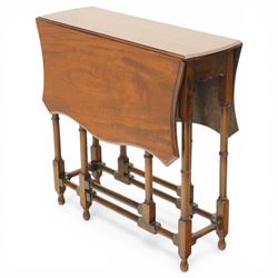 Edwardian mahogany Sutherland table, shaped rectangular drop-leaf top with canted corners and moulded edge, raised on ring-turned gate-leg base united by stretchers