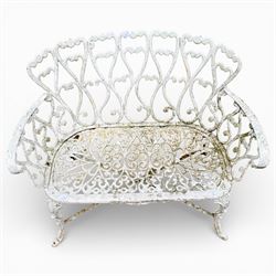 White cast metal garden bench in an antique style