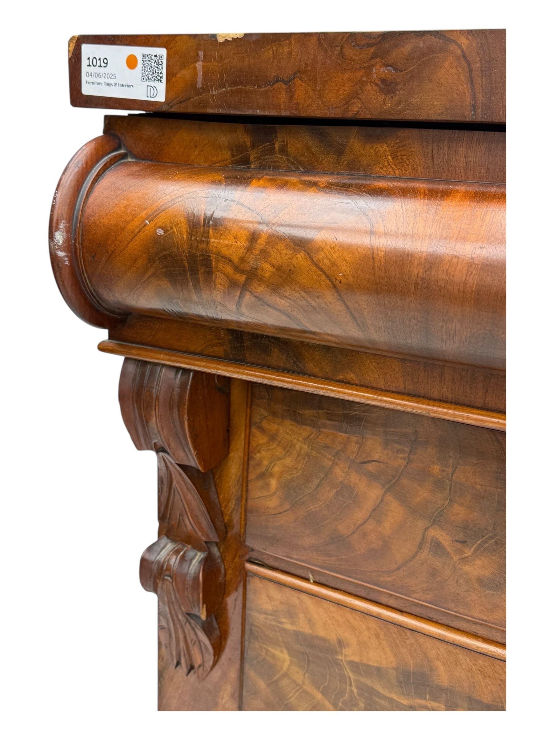 19th century flame mahogany Scotch chest, frieze long drawer above two short and four long graduating drawers, with turned knobs scrolled carved side bracket 