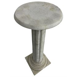 Classical design white granite pedestal, the circular plinth over a fluted column with a carved egg and dart collar, the turned circular base terminating in a square plinth with reeded edge
