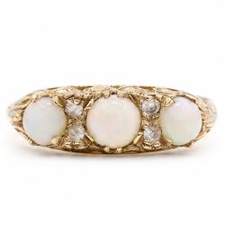 9ct gold three stone opal ring, with four diamond accents set between, Birmingham, 1971