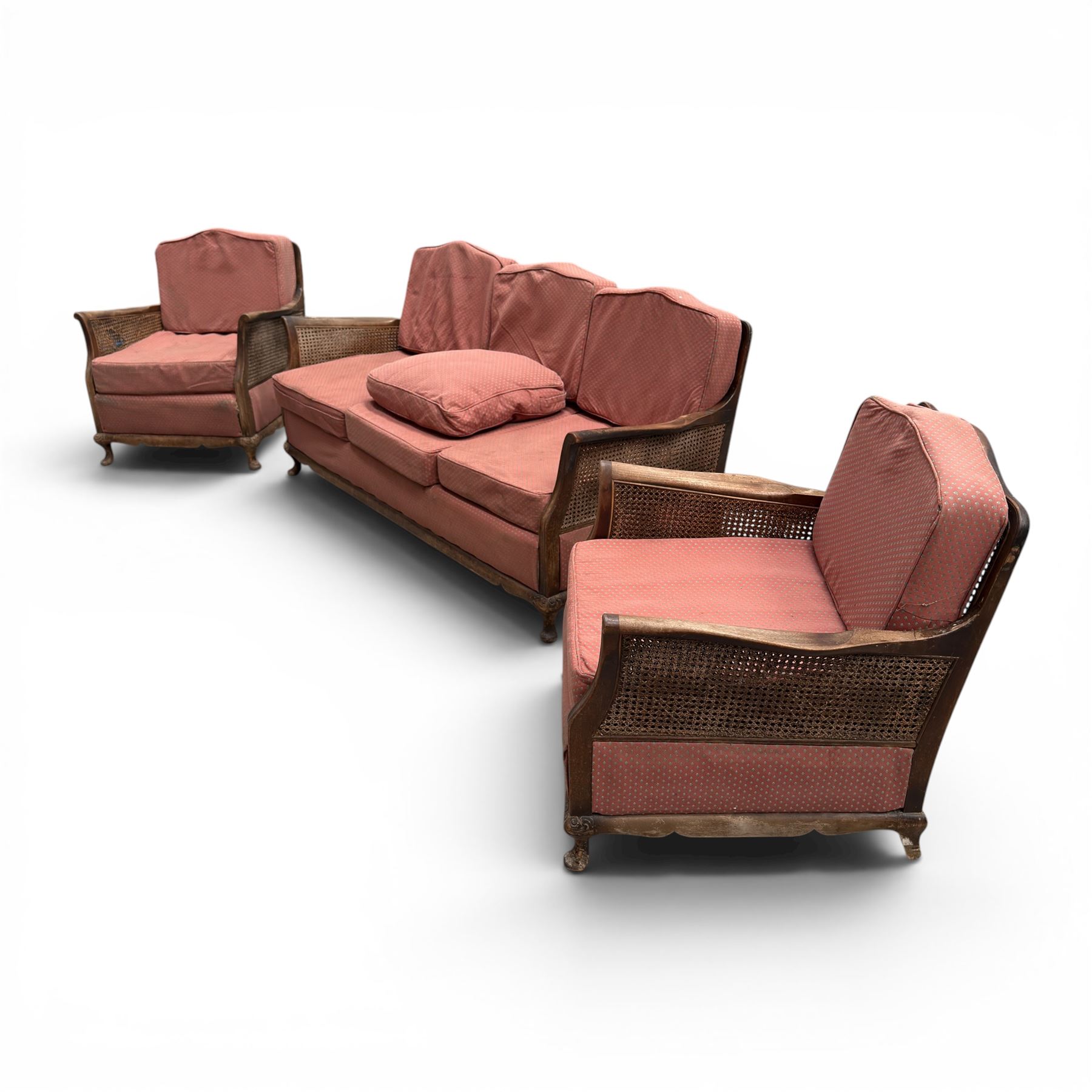 Early 20th century French style bergère conservatory suite, canework back and sides with red upholstered loose seat cushions, on cabriole feet