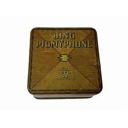 Gebruder Bing Germany Pigmyphone child's portable toy gramophone in woodgrain finish tin-plate box with key and tin of needles L15cm; and nine small records of nursery rhymes; together with a Japanese tin-pate 'Skip Rope Animals' clockwork toy, boxed.