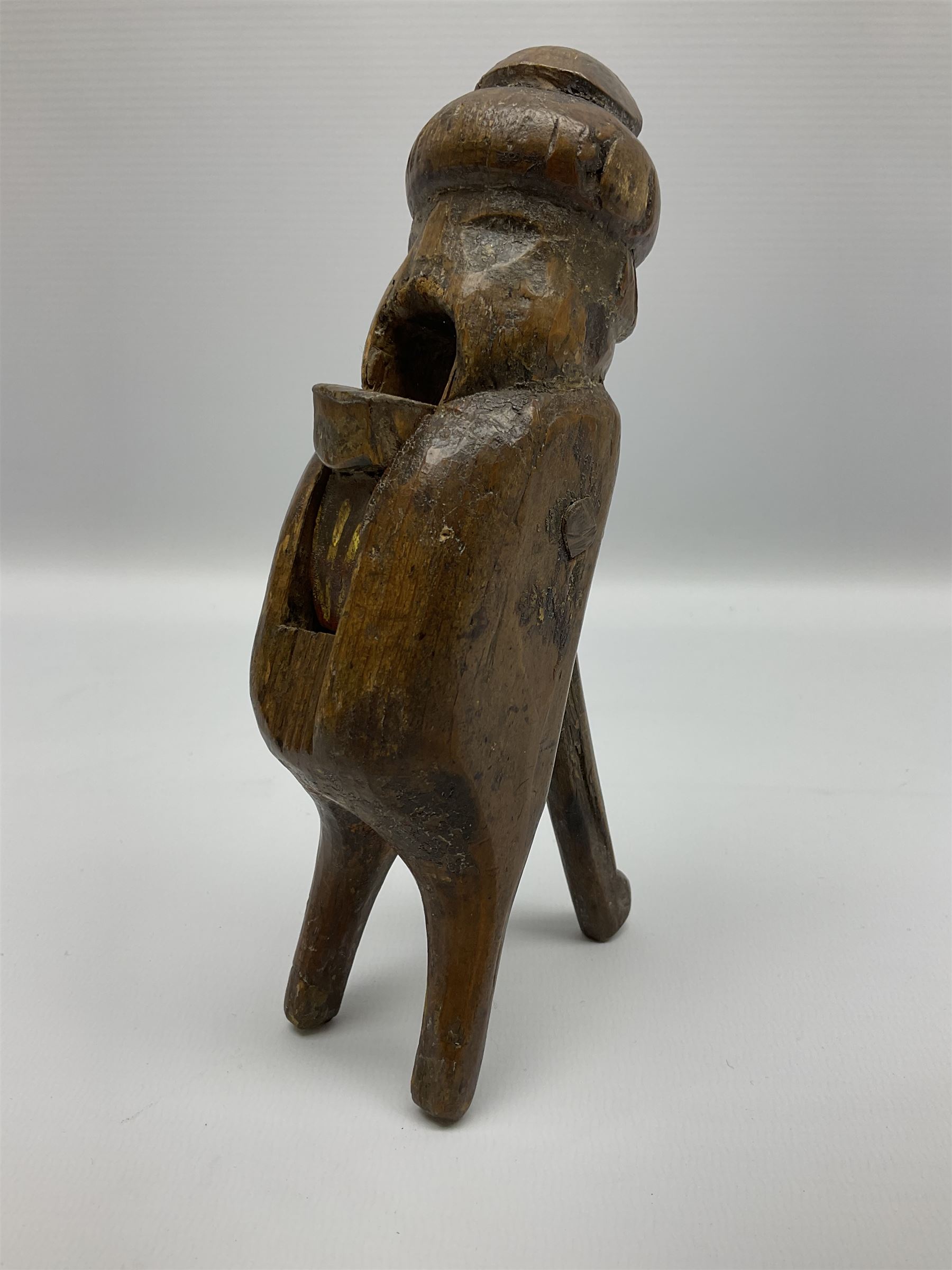 Rare primitive treen lever action nutcracker, probably late 17th/early 18th century, carved in the form of a man, with old collector label to side inscribed 'A Nutcracker XVI Century', H18cm