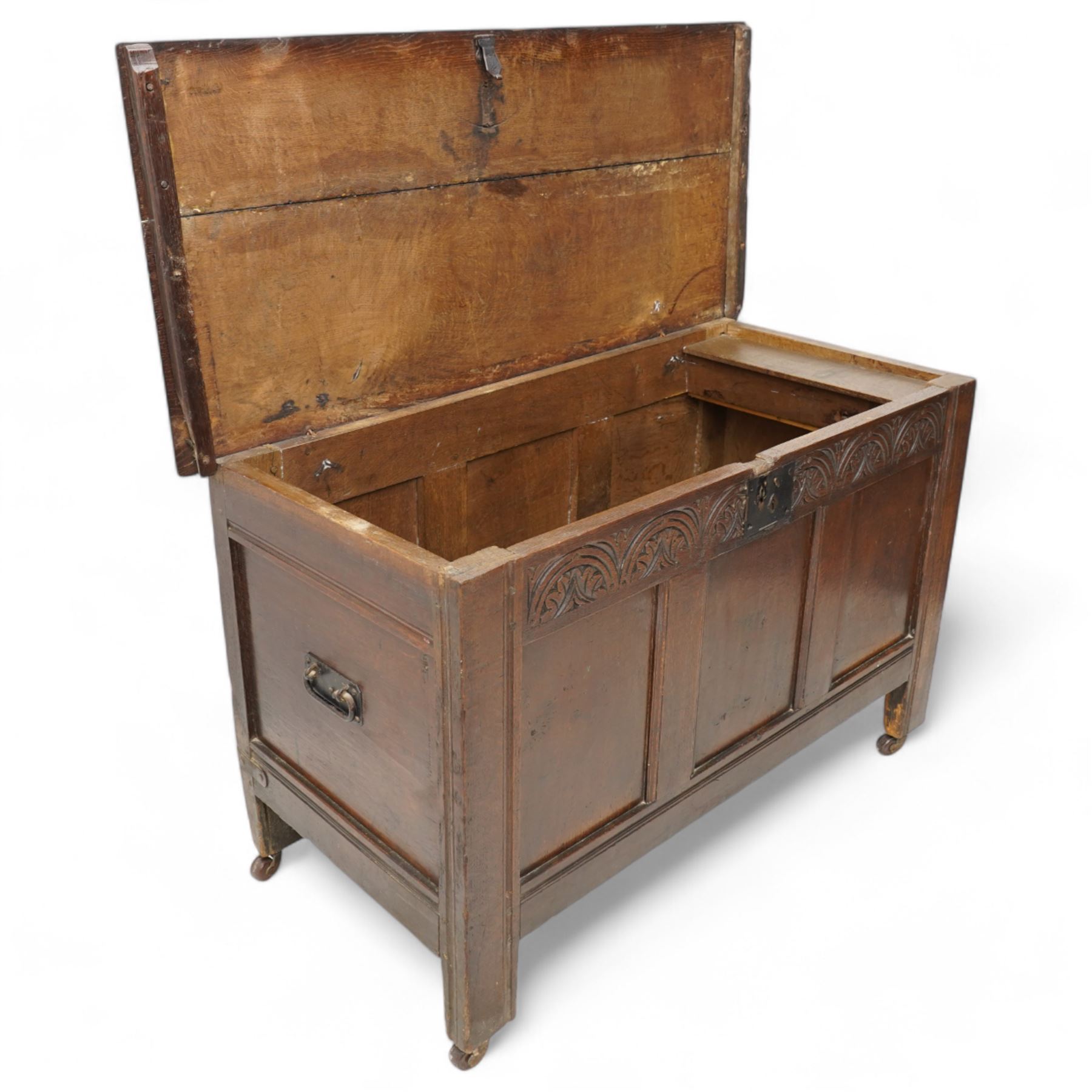 18th century oak blanket box, moulded rectangular hinged lid over lunette carved frieze rail and panelled front, moulded frame and panelled sides fitted with carrying handles, on stile supports