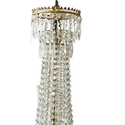 Regency Country House cut-glass and ormolu six light chandelier, the outer shaft with ormolu foliate moulding hung with octagonal and drop pendants, the impressive central shaft with cascading drops of cut-glass, the scroll branches with hob-nail cut candle holders and wax pans, with central similarly cut terminal
Provenance: property of a nobleman